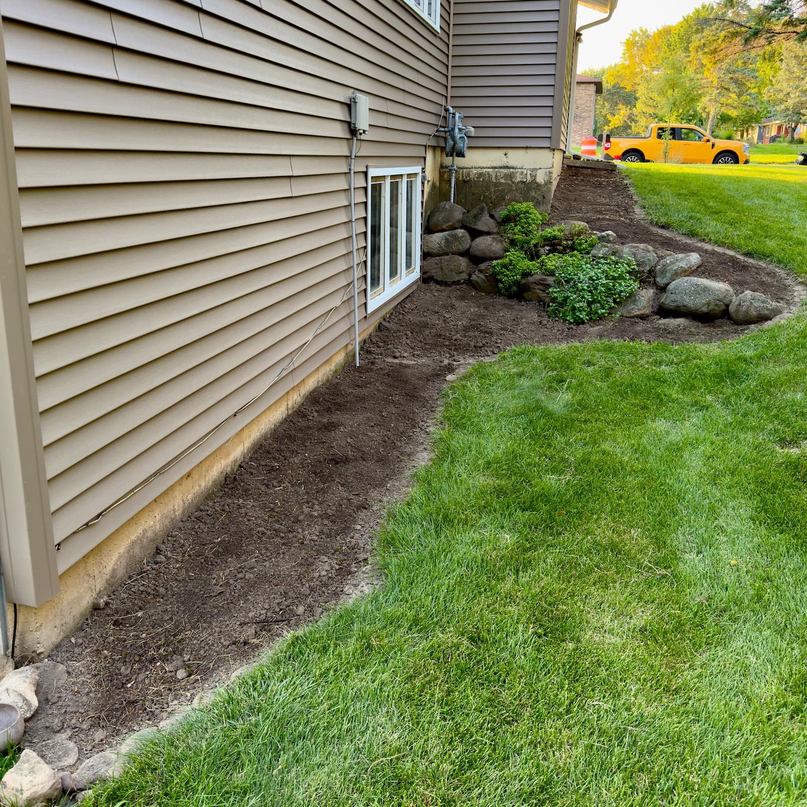 Garden bed on Raymond Rd in Madison, WI after weed removal, compost tea application, and clover seeding.